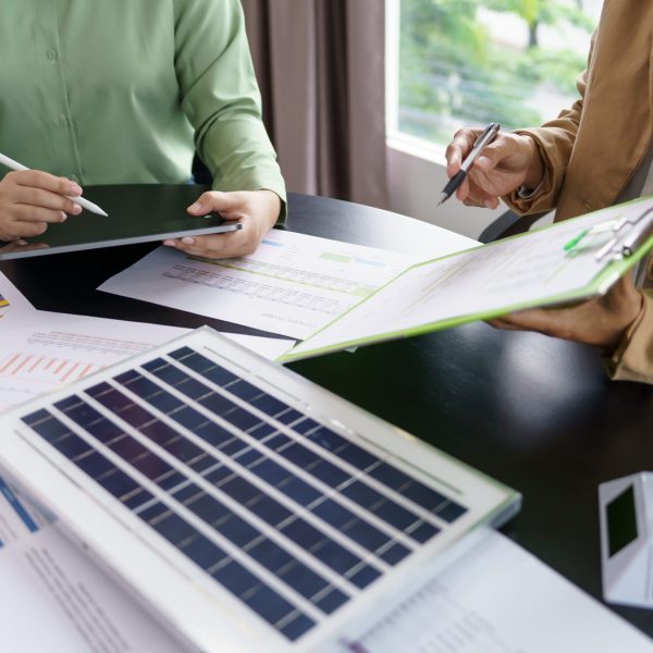Solar panels green energy Business people working in green eco friendly office business meeting creative ideas for business eco friendly professional teaching corporate people sustainable electricity